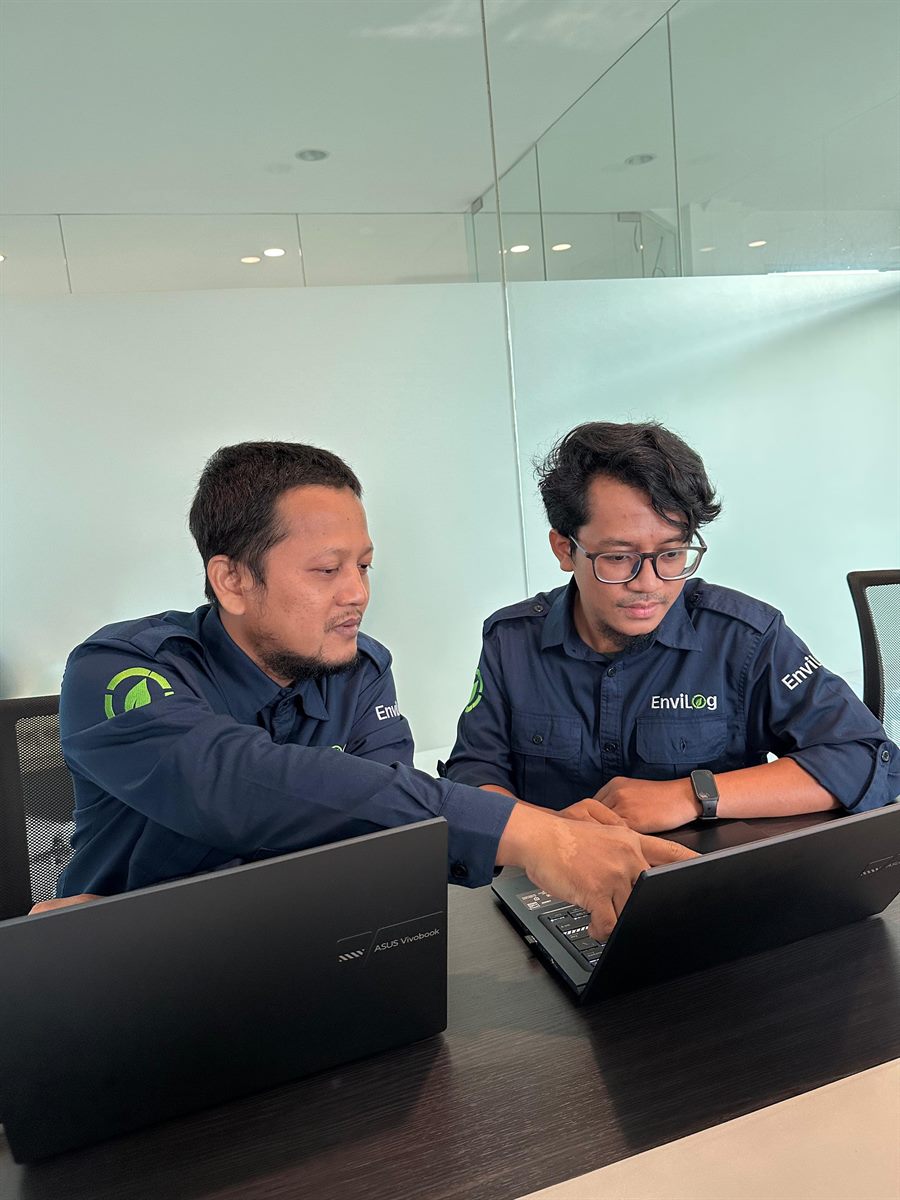 EnviLog engineers collaborating at a laptop
